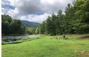 Small mountain lake is the center of recreation for vacationers and event guests.